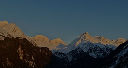 Scenic view of snowcapped mountains against clear sky