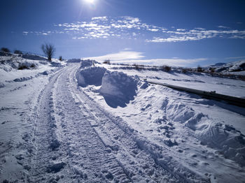 Snow covered landscape against sky