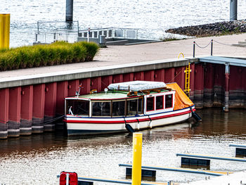 Boats moored on river against buildings in city