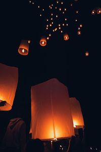 Low angle view of illuminated lantern against sky at night