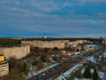 High angle view of road by buildings against sky