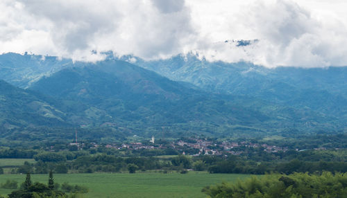 Scenic view of landscape and mountains against sky