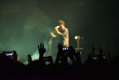 People photographing at music concert