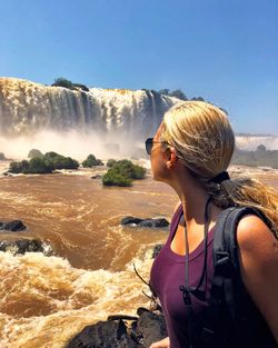 Woman looking at iguacu falls