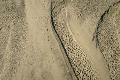 High angle view of tire tracks on beach