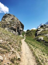 Road by mountain against sky