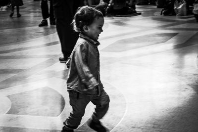 Side view of cute girl walking on floor