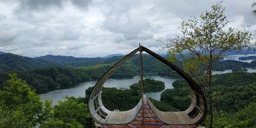 Arch bridge over river against sky