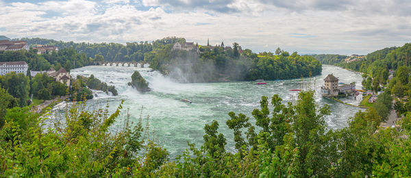 Scenic view of waterfall against sky