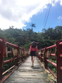 Rear view of man on footbridge