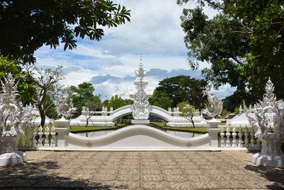 Statue amidst trees against sky