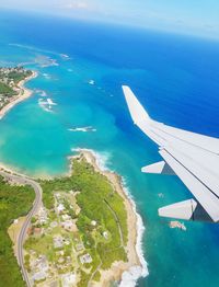 High angle view of airplane flying over sea