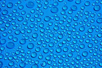 Close-up of water drops on blue surface