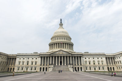 Low angle view of government building against cloudy sky