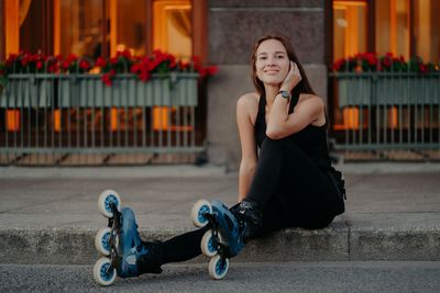 Portrait of young woman sitting outdoors