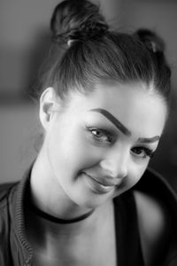 Close-up portrait of smiling young woman