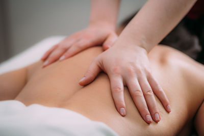 Back massage in a massage salon, woman having a relaxing back massage.