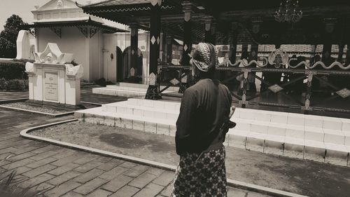 Woman standing in front of building