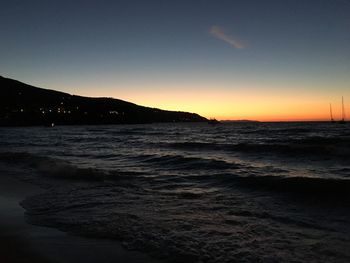 Scenic view of beach against sky during sunset