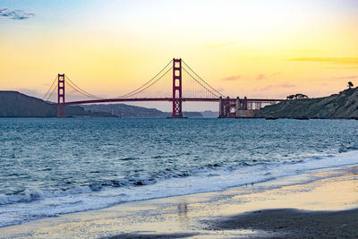 View of suspension bridge at sunset