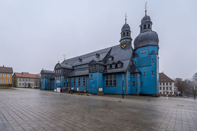 Buildings in city against clear sky