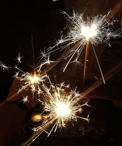 Low angle view of firework display at night