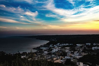 High angle view of townscape by sea against sky