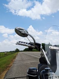 Bicycle on road against sky in city