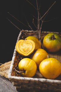 Close-up of fruits in basket on table