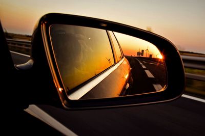 Reflection of car on side-view mirror