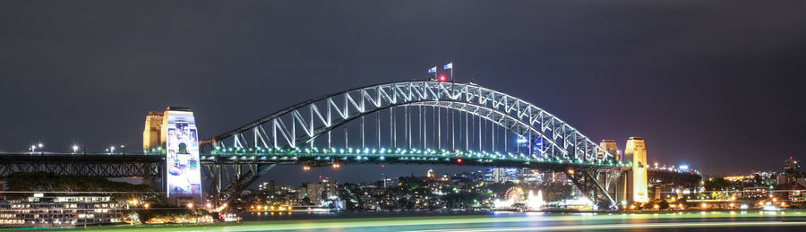 Suspension bridge over river at night