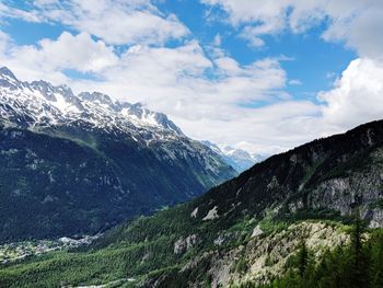 Scenic view of mountains against cloudy sky