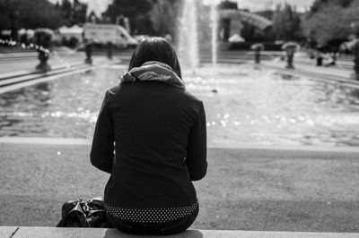 Rear view of woman standing in water