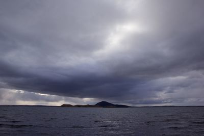 Scenic view of sea against cloudy sky