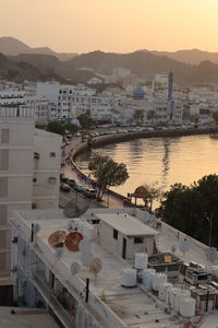 High angle view of townscape by river against sky