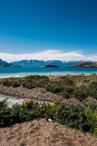 Scenic view of sea against blue sky