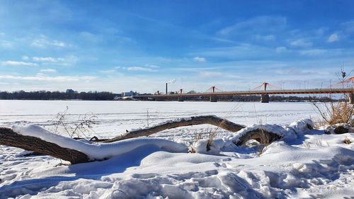 Scenic view of snow covered field against sky