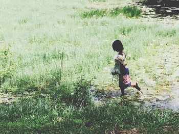Full length of girl standing on field