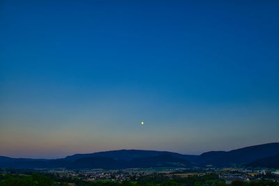 Scenic view of mountains against clear blue sky