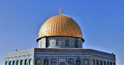 Low angle view of the dome of the rock against blue sky