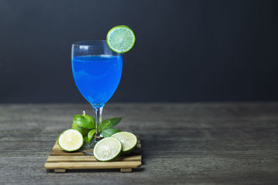 Green drink on table against black background