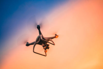 Low angle view of camera against sky during sunset