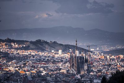 Aerial view of illuminated city against sky