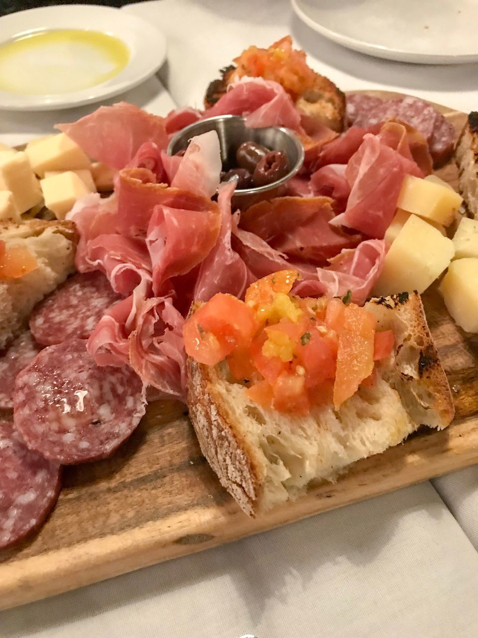 CLOSE-UP OF CHOPPED VEGETABLES ON PLATE WITH BREAD