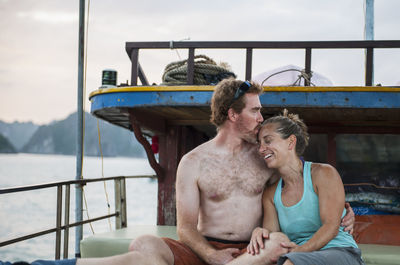 Mid adult couple relaxing on a boat in halong bay in vietnam