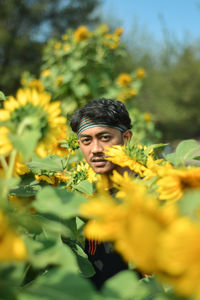 Portrait of woman on yellow flowering plants