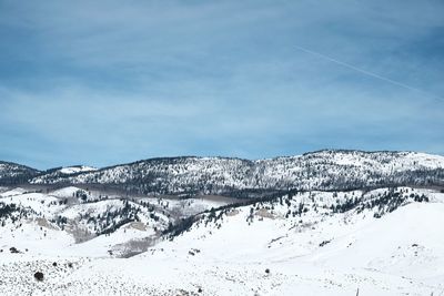 Scenic view of snow covered mountains against sky