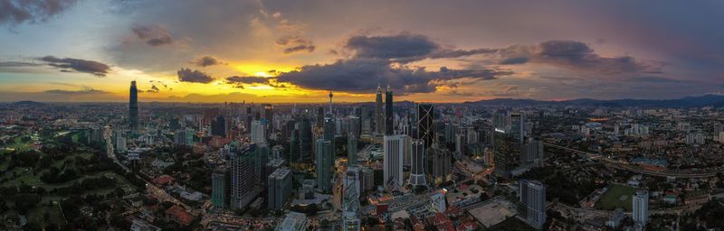 High angle view of modern buildings against sky during sunset