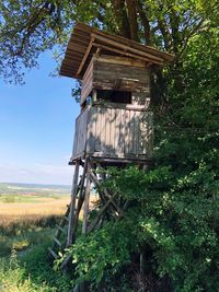 Abandoned built structure on field against sky