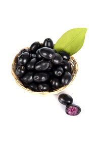 Close-up of black berries over white background